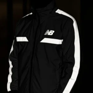 Black jacket featuring thick, high-visibility reflective stripes on the arms and chest, and a reflective logo, visible in the dark.