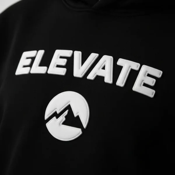 A close up of puff print text and logo on a black hoodie.